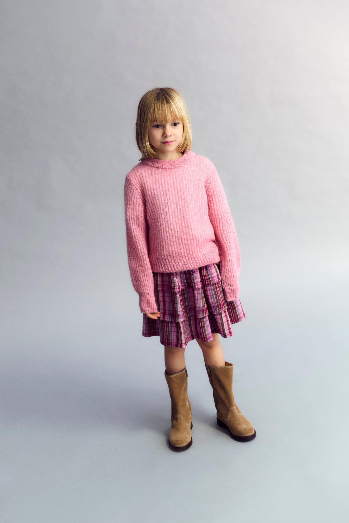 Fine rib knit mohair sweater with a round neckline and ribbing at the neck, cuffs, and hem.  It feautures a TNS embroidery on tone on hem rib.