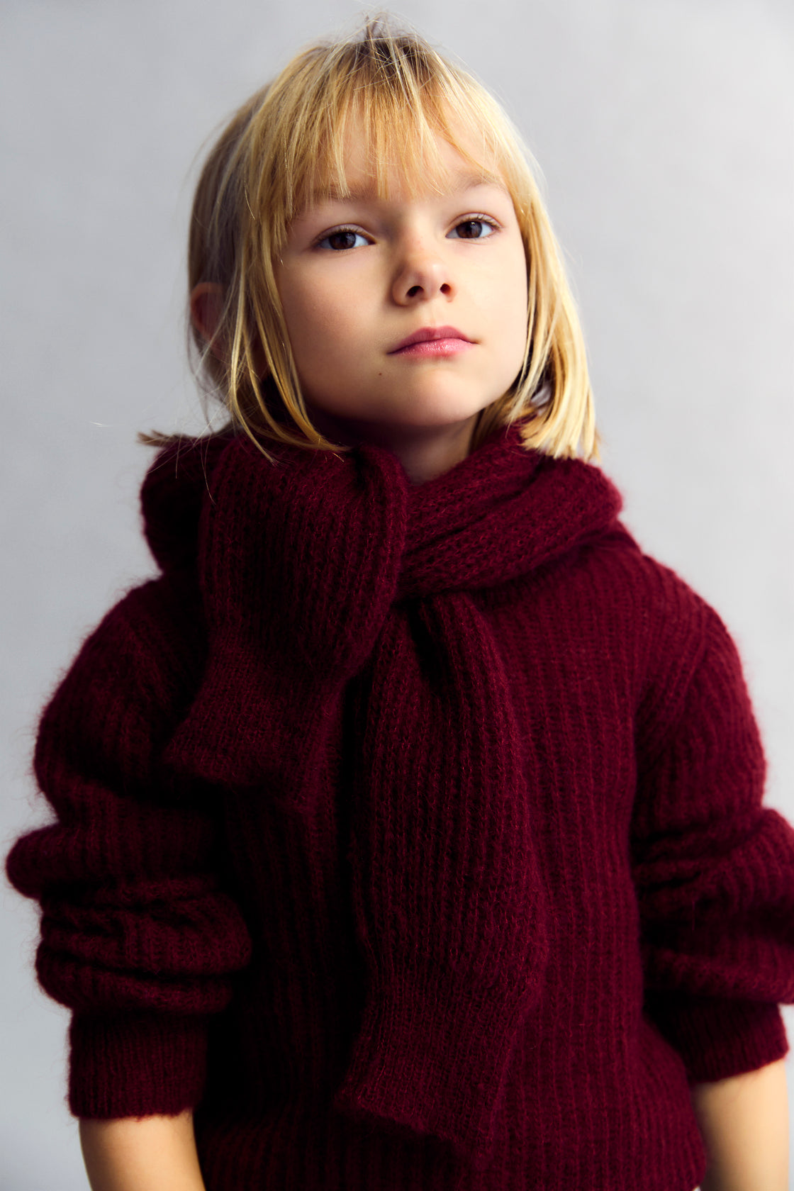 
Fine rib knit mohair sweater with a round neckline and ribbing at the neck, cuffs, and hem.  It feautures a TNS embroidery on tone on hem rib.