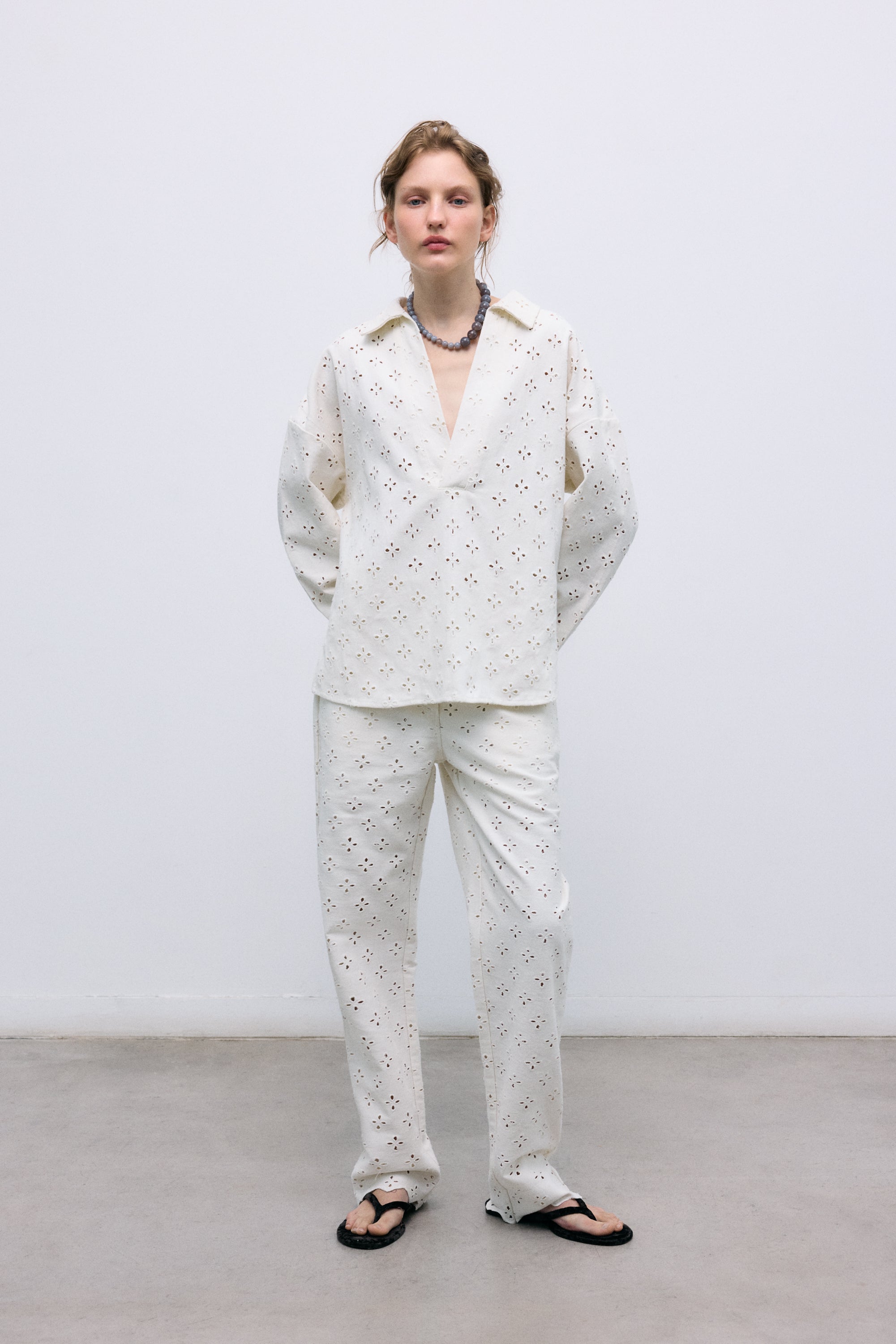 Denim pants crafted from a delicate fabric with all-over embroidery for a refined and unique finish.