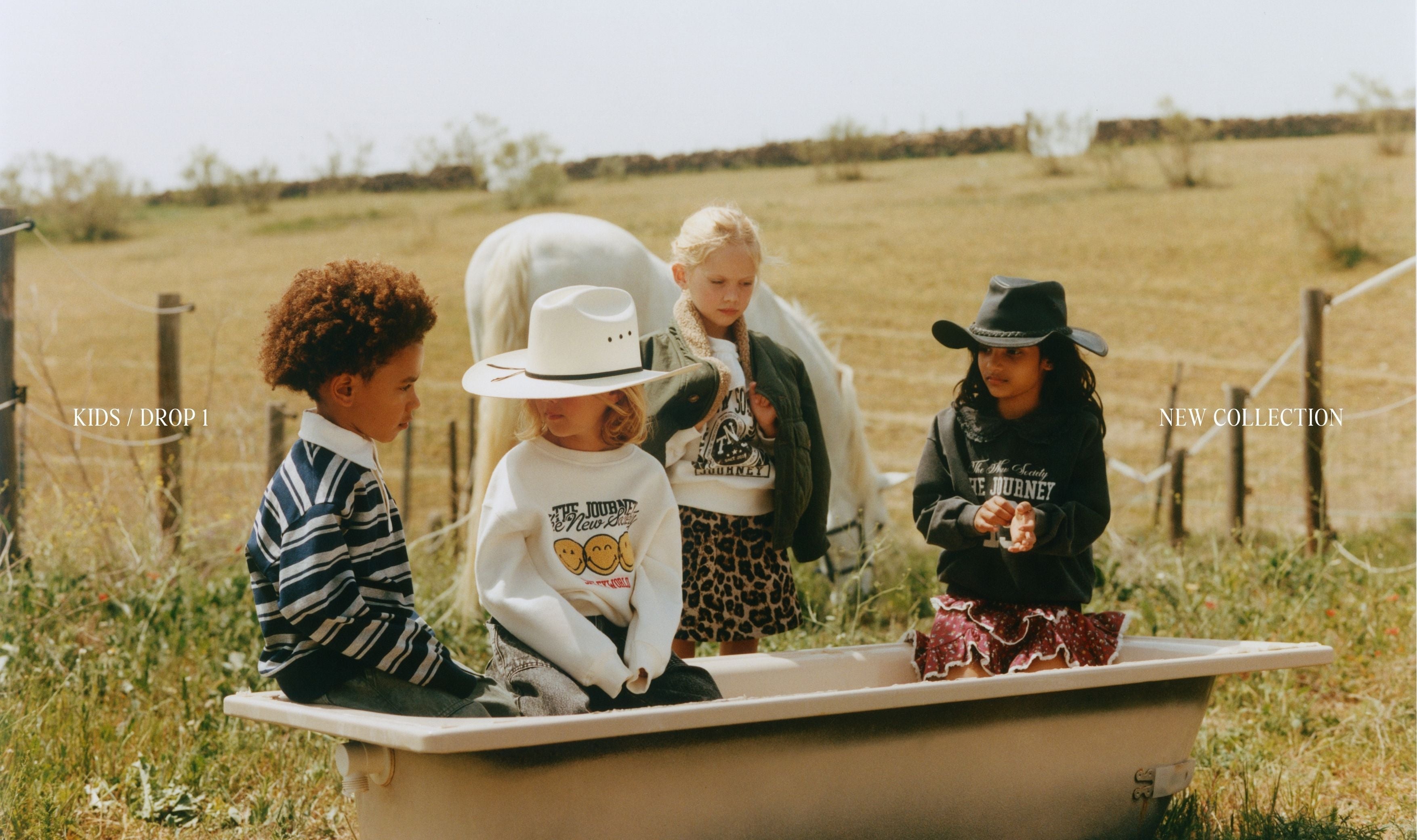 A group of children together wearing looks from the Campalà AW26 collection. They smile, interact naturally, and enjoy a shared moment, showcasing timeless designs, soft textures, and warm seasonal colours that capture the spirit of childhood.
