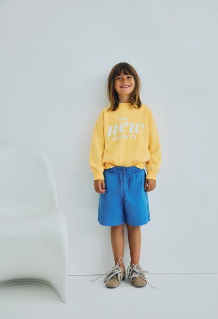 Soft cotton bermuda shorts featuring side and back pockets, a tone-on-tone adjustable drawstring waistband with contrast speckles,