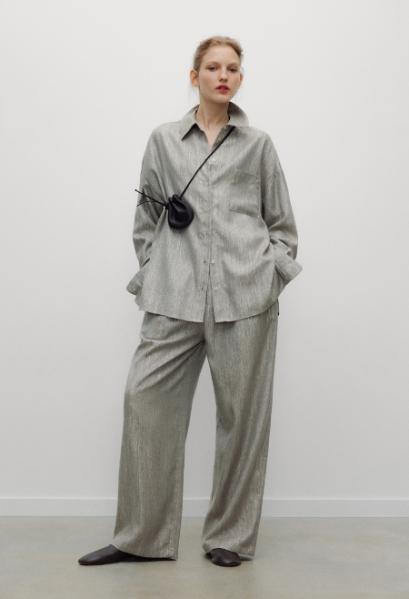 The Iris Woman Shirt is an elevated wardrobe staple, crafted from a soft viscose blend with a subtle shimmering finish that brings texture and understated elegance. 