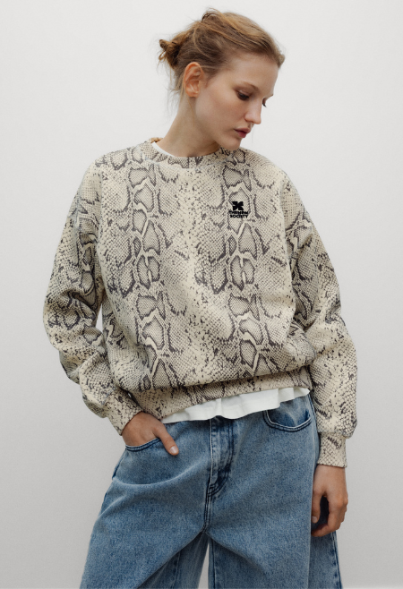 The TNS Logo Woman Sweatshirt combines everyday comfort with a bold contemporary attitude. Crafted from soft 100% cotton, this relaxed-fit sweatshirt is reimagined in an eye-catching Snake Prin
