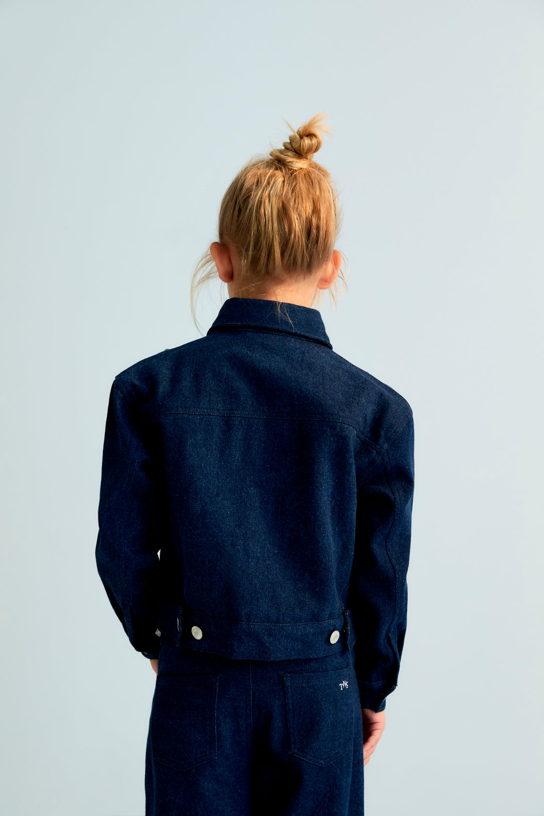 Dark denim jacket with hand-applied multicolored crystal details. TNS embroidery in lurex. Perfect for pairing with the matching pant.