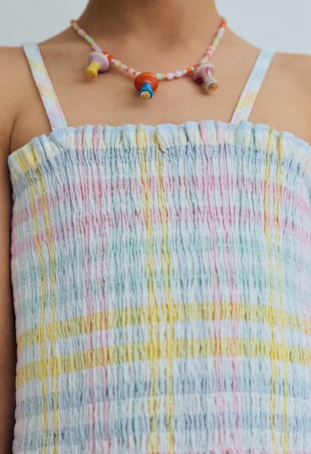 Top in cotton seersucker with multicolor checks, featuring all over smocking that creates a comfortable and flattering fit.