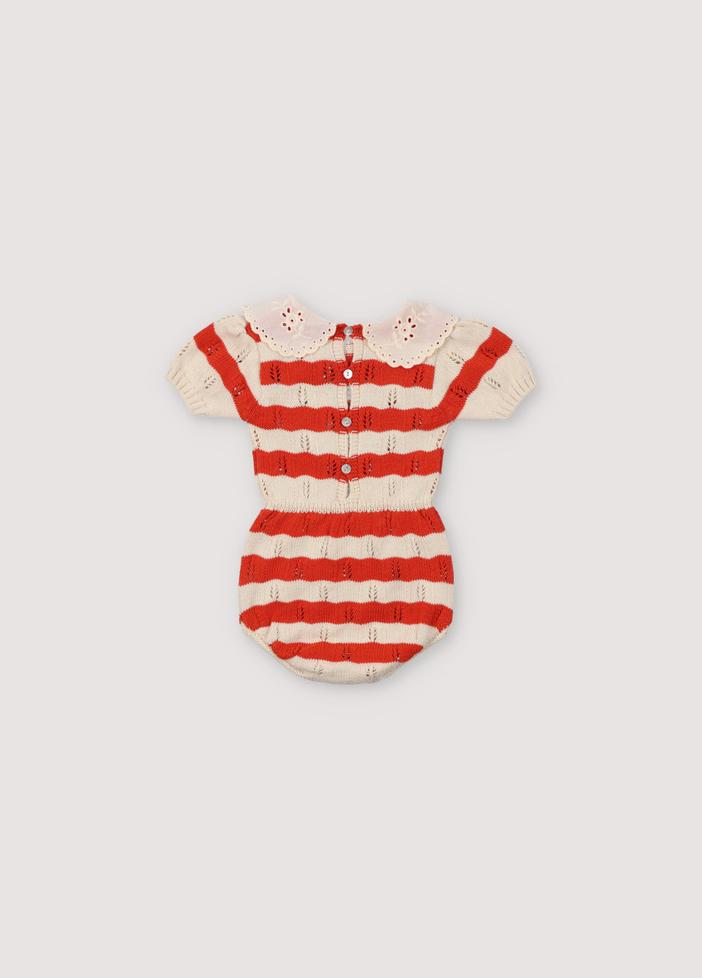 Bicolor striped romper with contrast lace collar detail. It has elastic waistband and cuffs, and an opening with snaps and back with placket and mother-of-pearl buttons. Spirng Summer Collection. The New Society.