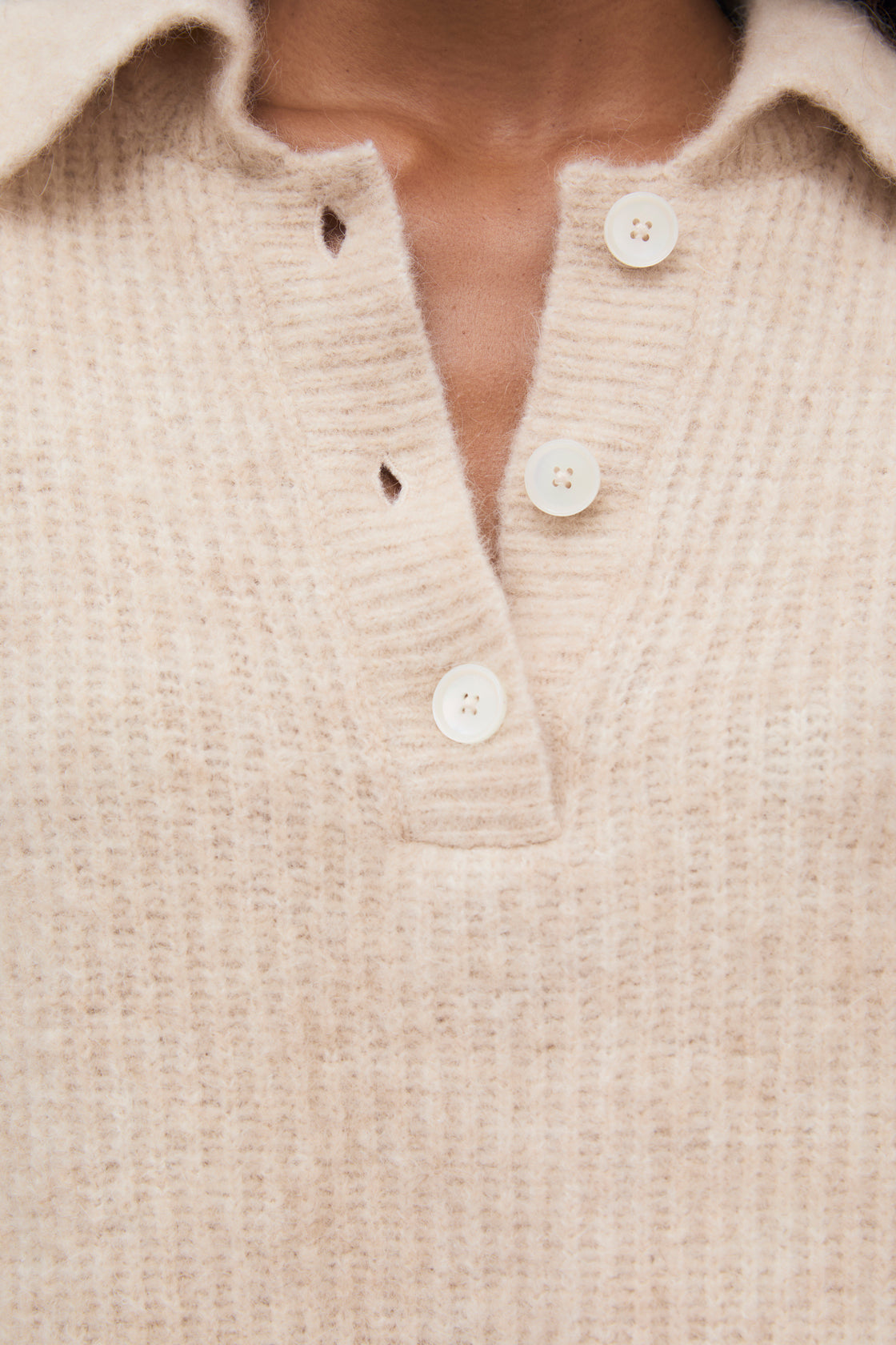 Wool knit polo crafted in exquisite quality, featuring a front placket opening with beautiful buttons in tone.