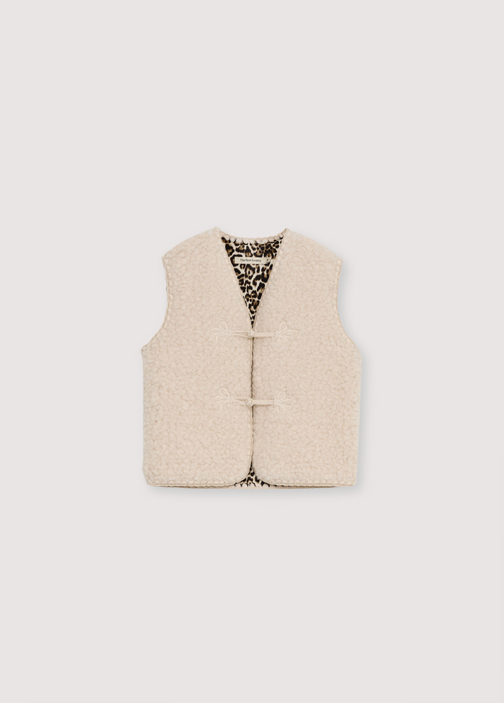Waistcoat with stitching details and a front closure with original toggles. It has an interior lining with a leopard print detail.