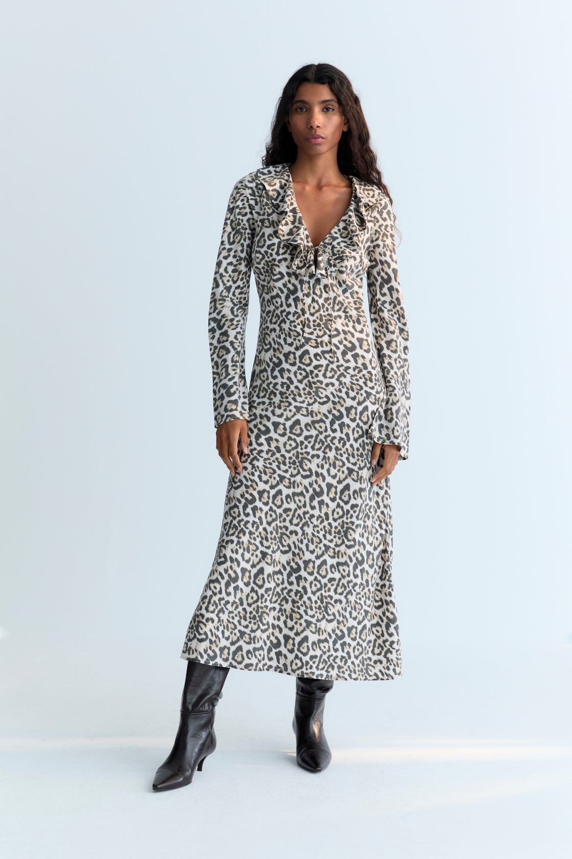 This long dress in our signature Nelia leopard print features a flattering V-neckline, delicate ruffle accents, and a tie closure at the front