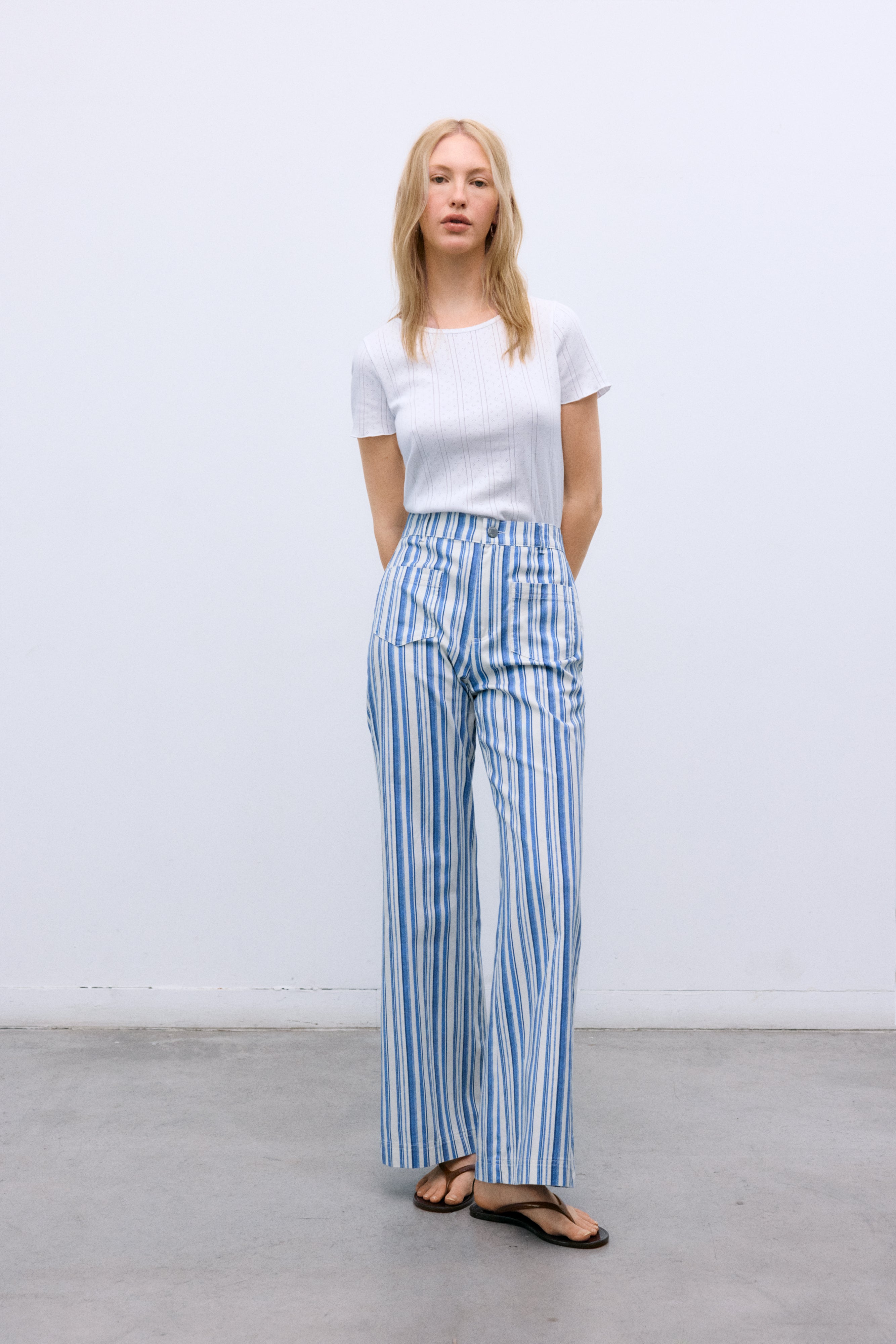 Women’s blue striped denim pants crafted with a refined contrasting stripe print that elevates a timeless silhouette.