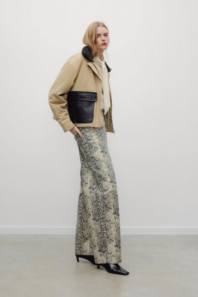The Flint Woman Jacket is crafted from 100% cotton, offering a structured yet comfortable feel for everyday wear