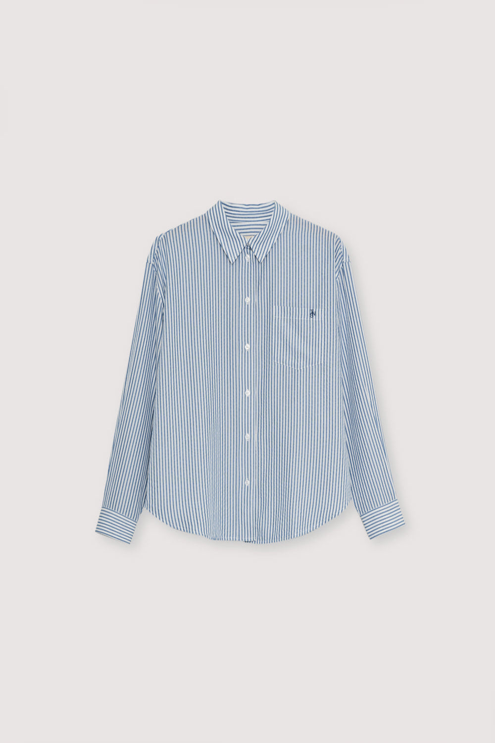 Fluid tencel fabric shirt in a beautiful bicolor stripe. It features a patch pocket on the front and brand embroidery detail.