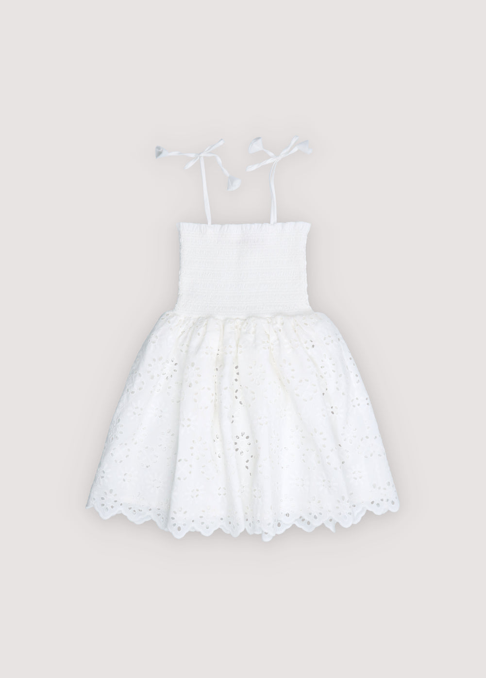 Short dress in beautiful embroidered cotton fabric, featuring a smocked bodice with ruffle detail for a comfortable and flattering fit.