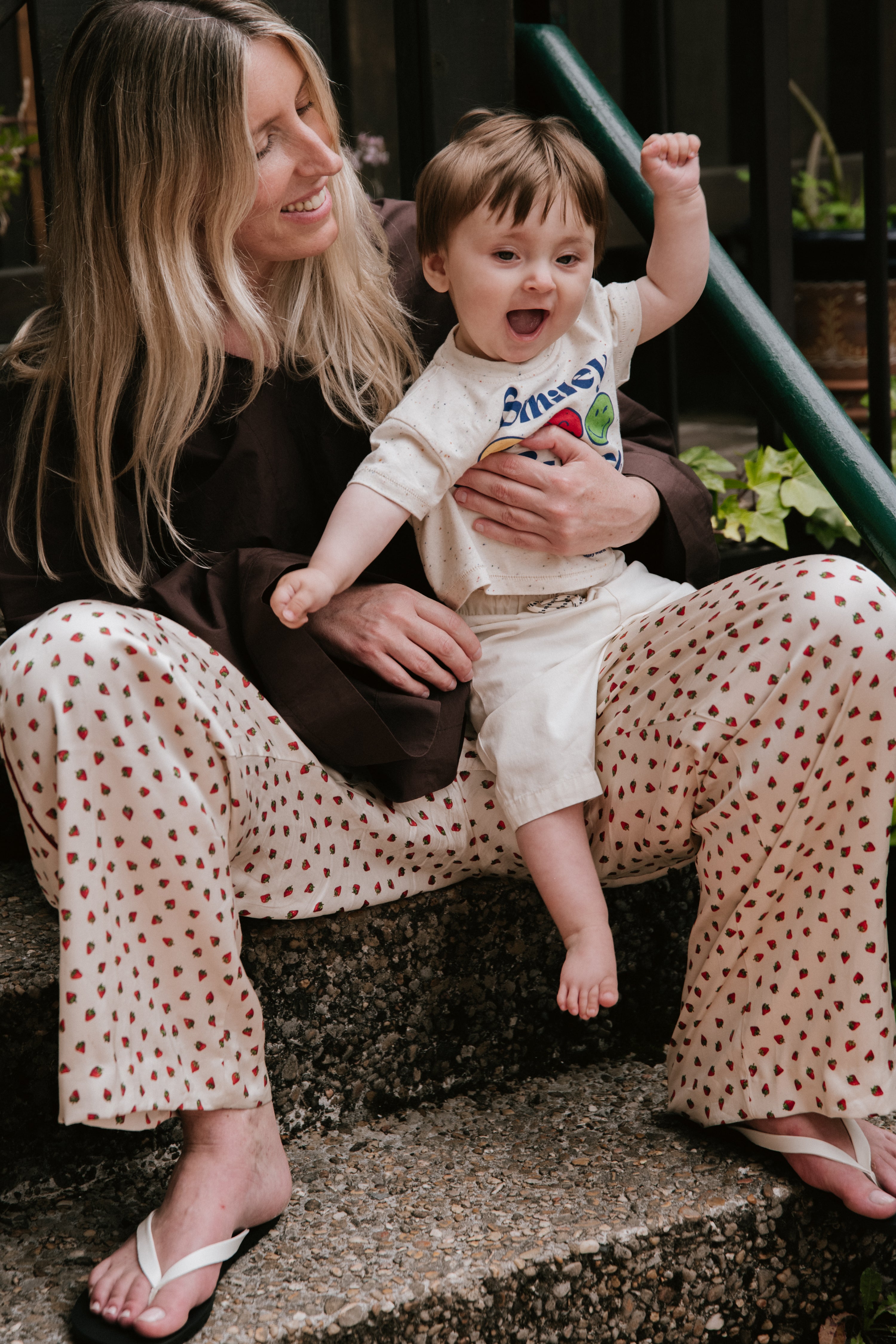 Fun speckled jersey T-shirt featuring a SmileyWorld® print on the front and shoulder snaps for easy wear, adding a playful, practical touch.