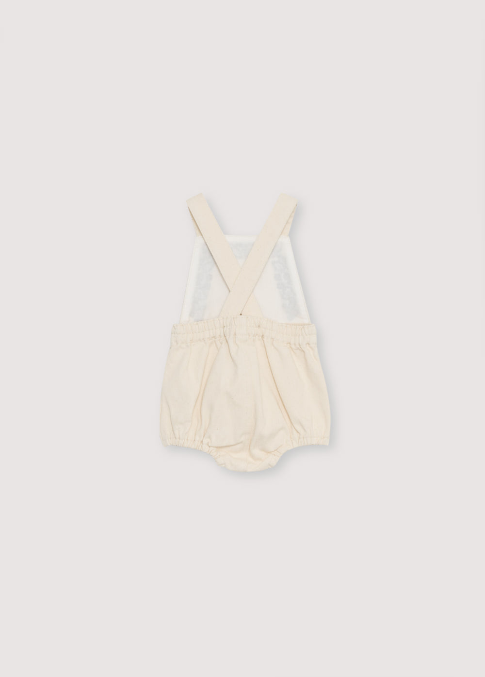 Denim romper with adjustable straps at the back and contrast embroidery detail on the front.