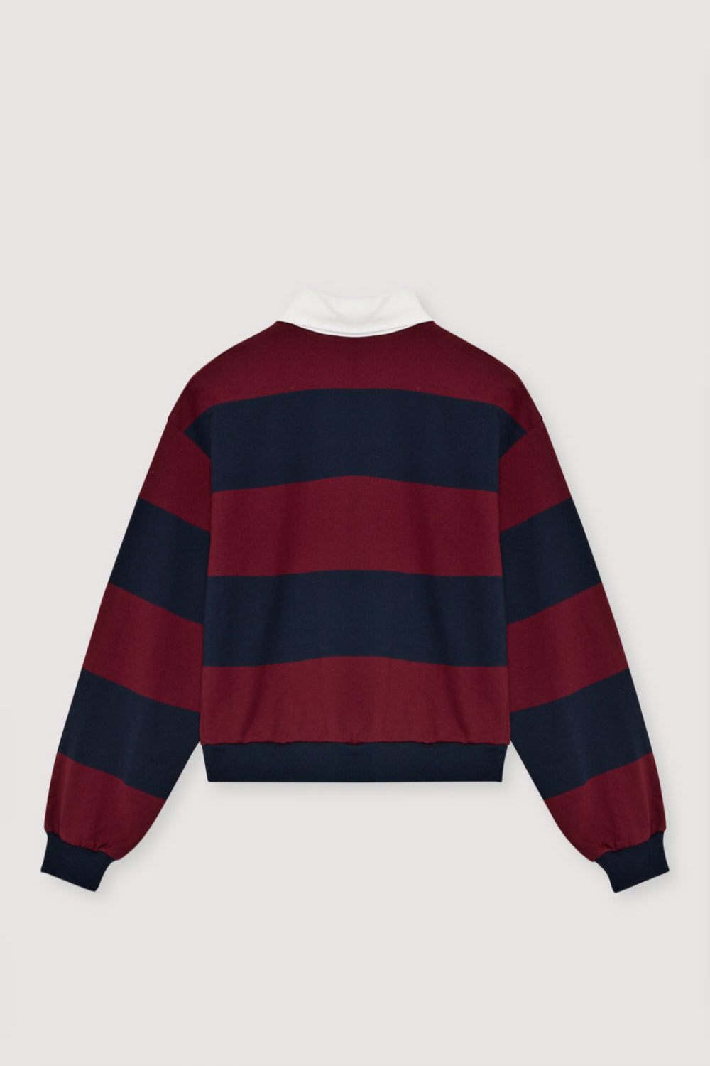 Bicolor striped crop polo with a contrasting collar in twill fabric. It features a contrasting print on the chest.