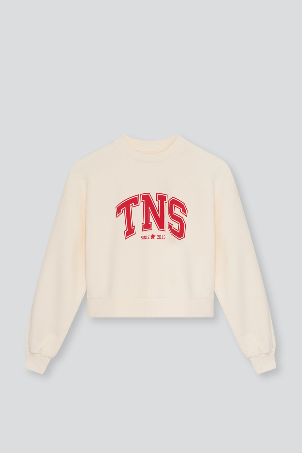 Crop sweatshirt in soft cotton fleece with ribbed collar and cuffs, featuring a contrasting TNS embroidery on the chest for a cozy yet stylish look.