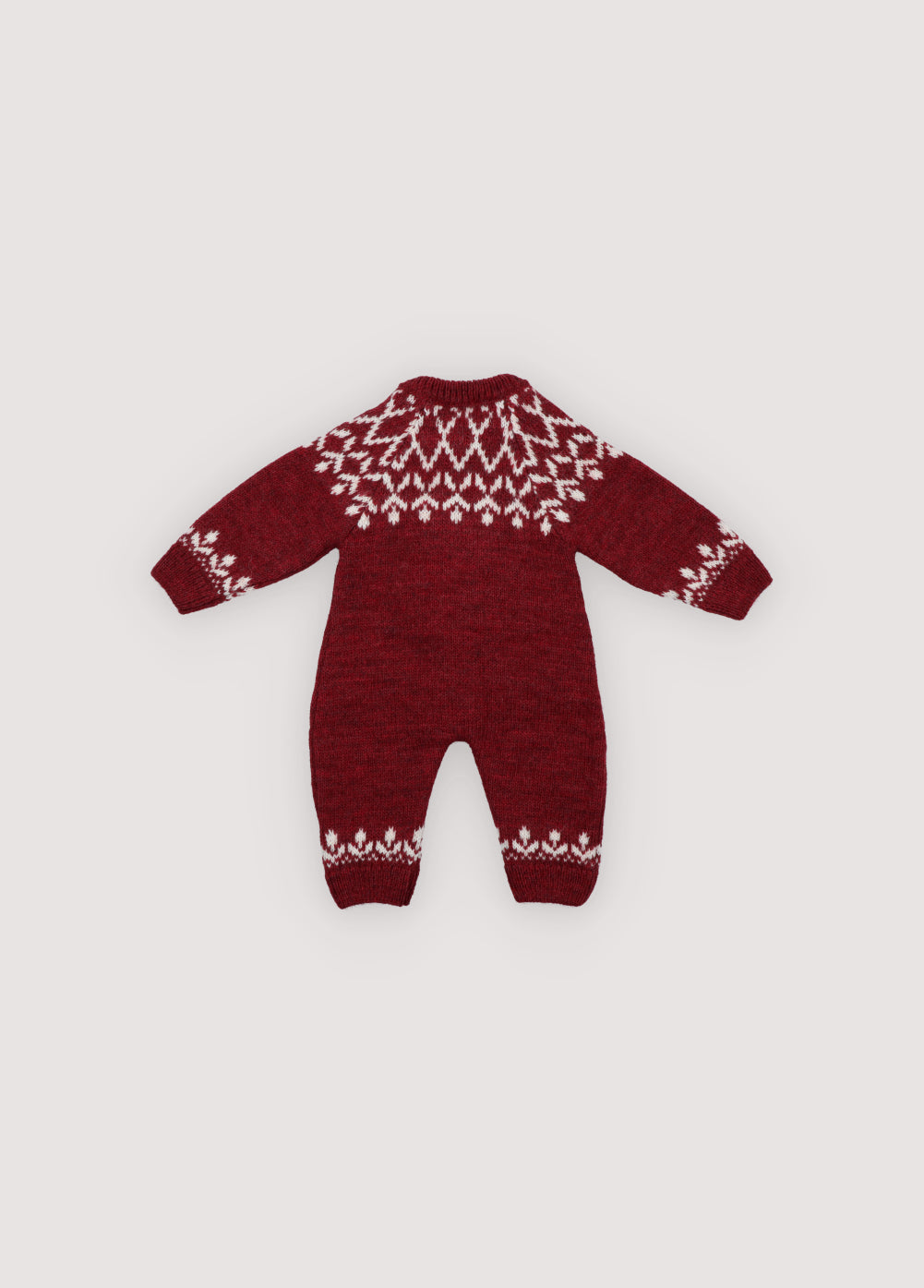 A cozy knitted romper in a festive plum color, featuring a charming white pattern across the chest, sleeves, and ankles. Soft, warm, and gently stretchy, it ensures all-day comfort for little ones. Designed with a front button closure and a relaxed fit, it’s perfect for easy dressing and carefree movement. Ideal for holiday gatherings or capturing seasonal memories in style.