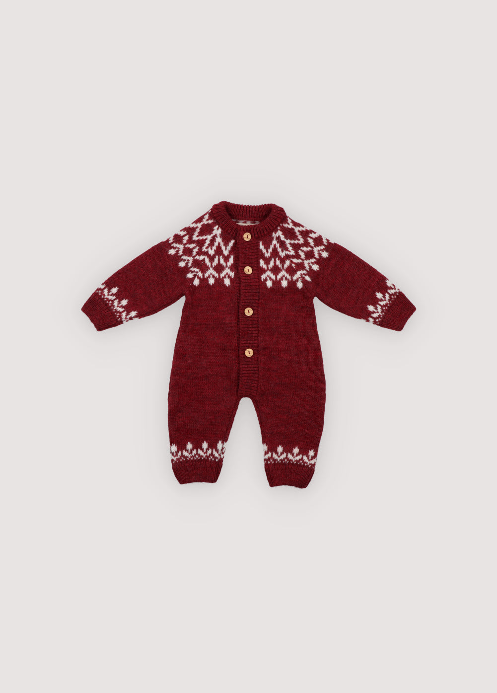 A cozy knitted romper in a festive plum color, featuring a charming white pattern across the chest, sleeves, and ankles. Soft, warm, and gently stretchy, it ensures all-day comfort for little ones. Designed with a front button closure and a relaxed fit, it’s perfect for easy dressing and carefree movement. Ideal for holiday gatherings or capturing seasonal memories in style.