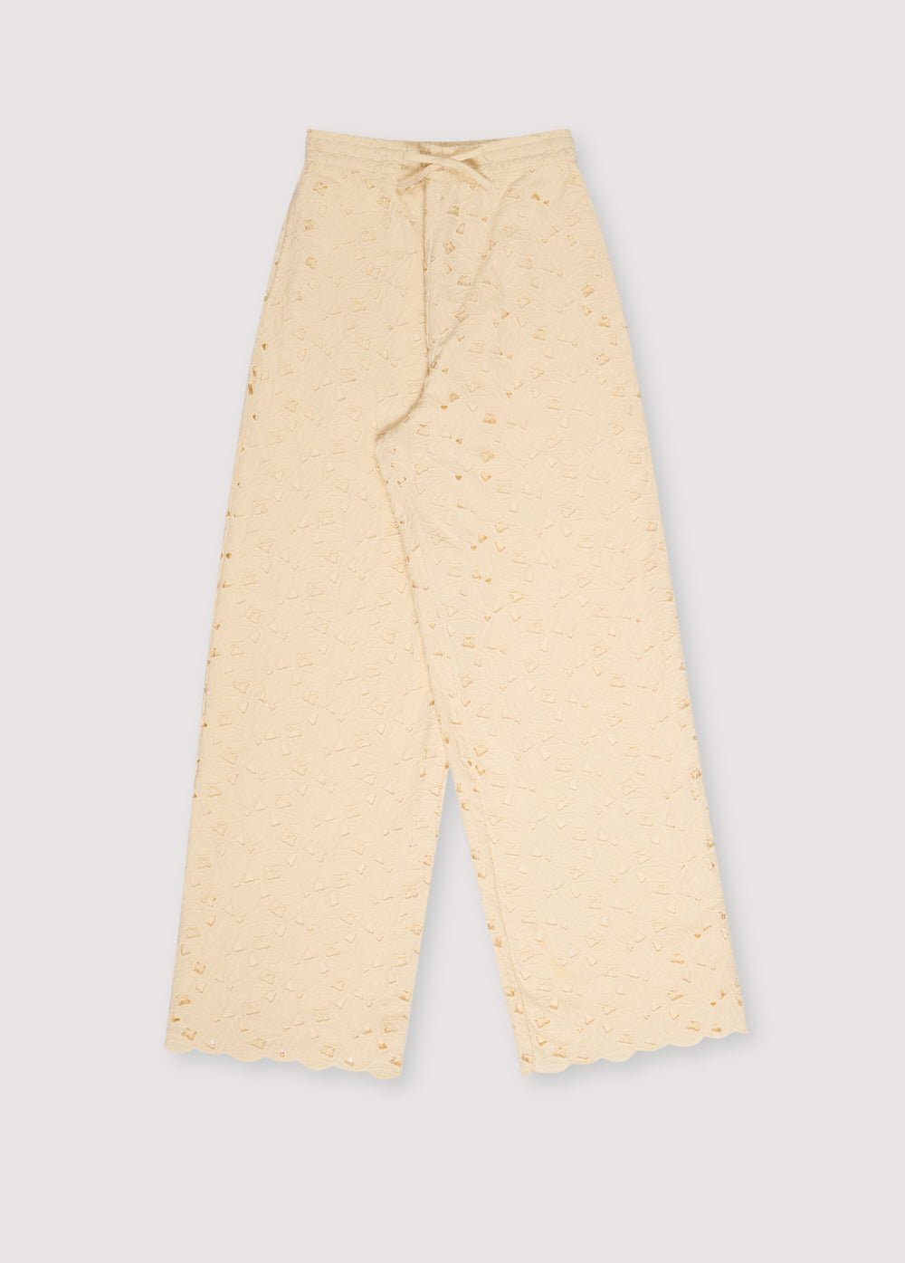 Atenea Woman Pant in embroidered blend cotton fabric in macadamia color, with an elastic waistband and a drawstring of the same fabric for adjustment.
