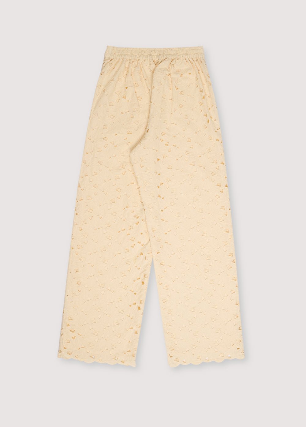 Atenea Woman Pant in embroidered blend cotton fabric in macadamia color, with an elastic waistband and a drawstring of the same fabric for adjustment.
