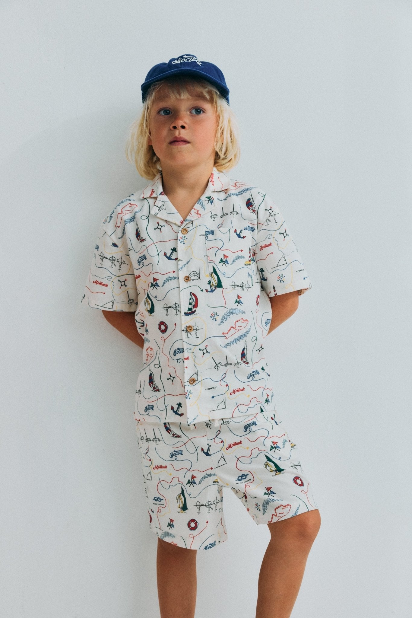 Short sleeve shirt in&nbsp;soft cotton featuring a unique multicolor map print and a front button closure with wooden buttons. 