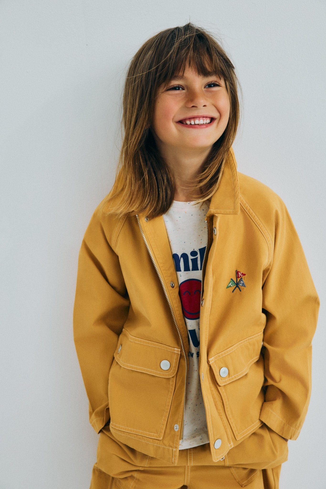 Sturdy canvas jacket featuring stitched pocket details and a soft corduroy collar.