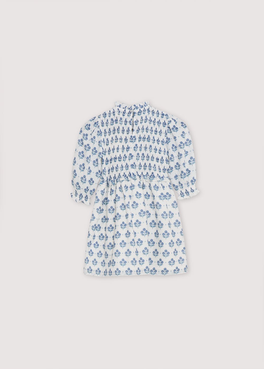 Eleni Dress in 100% cotton muslin fabric with our hyacinth print. The dress features a square neckline with smocking all over, puffed sleeves with smocking and a final ruffle, and a skirt with lots of volume.