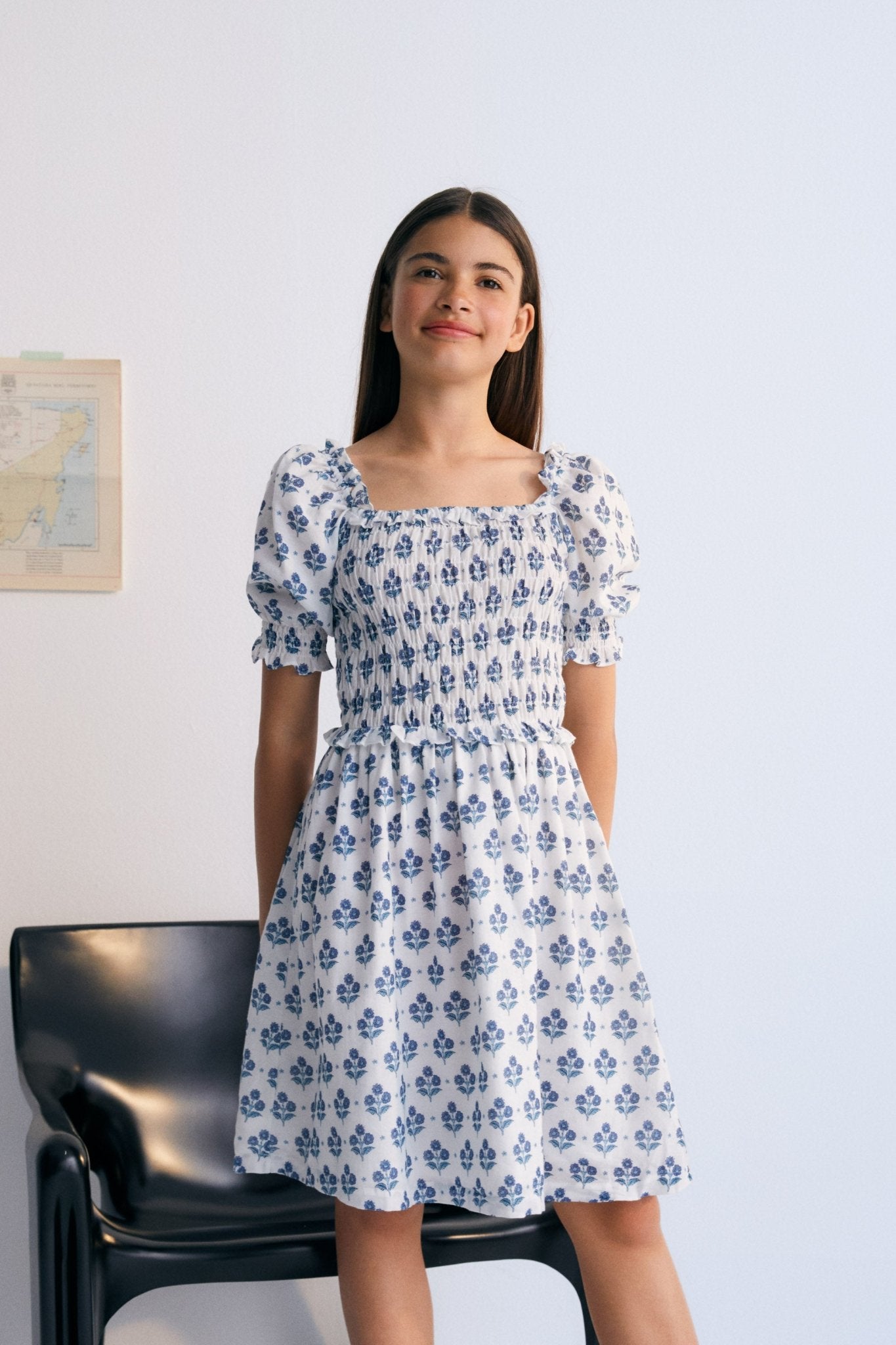 Eleni Dress in 100% cotton muslin fabric with our hyacinth print. The dress features a square neckline with smocking all over, puffed sleeves with smocking and a final ruffle, and a skirt with lots of volume.