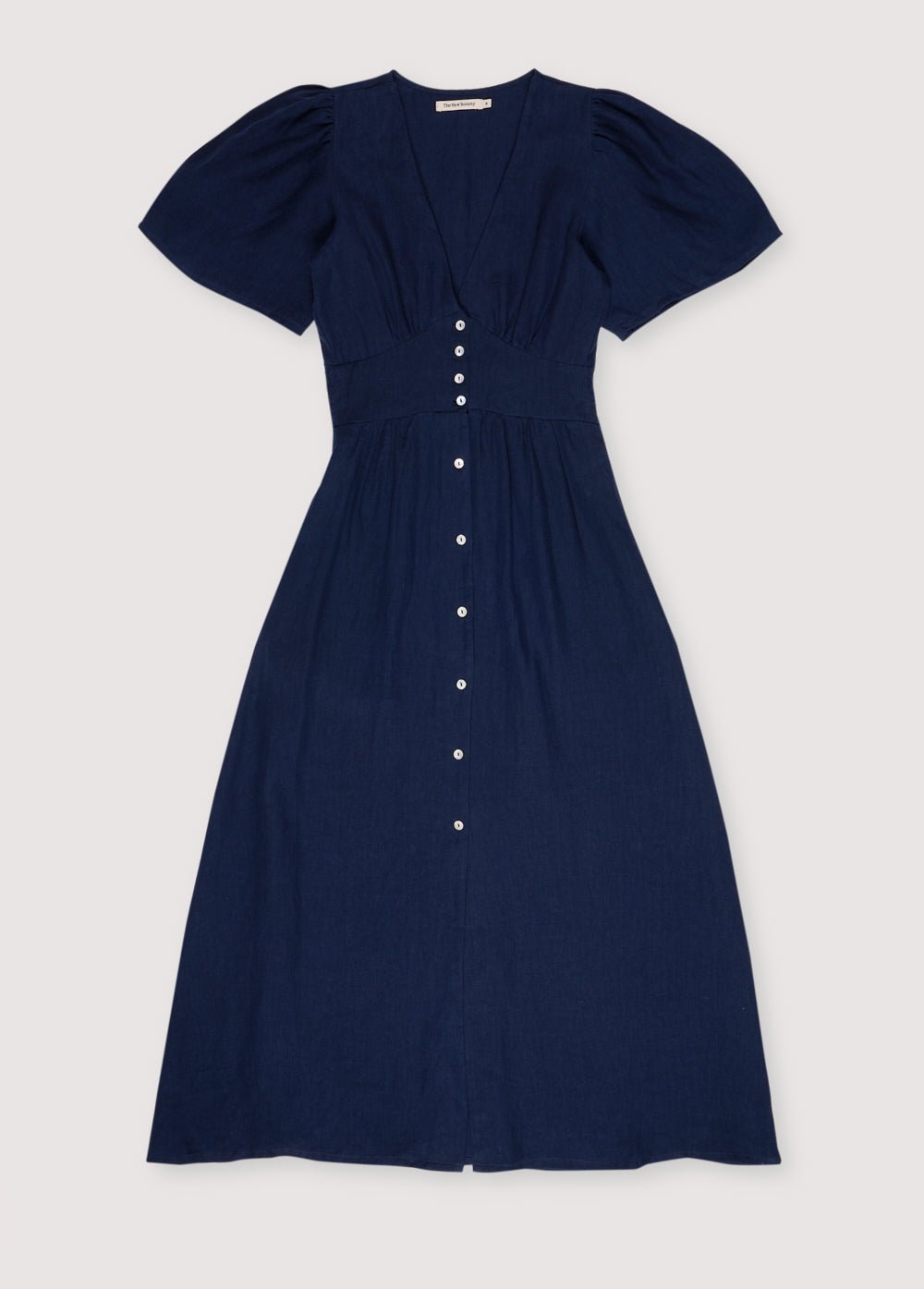 
Our bestseller now available in solid colors. Hera Woman Dress 2 in 100% linen, available in three colors: navy, hibiscus, and palm. V-neck, short sleeves with shoulder gathering, and center front buttons.