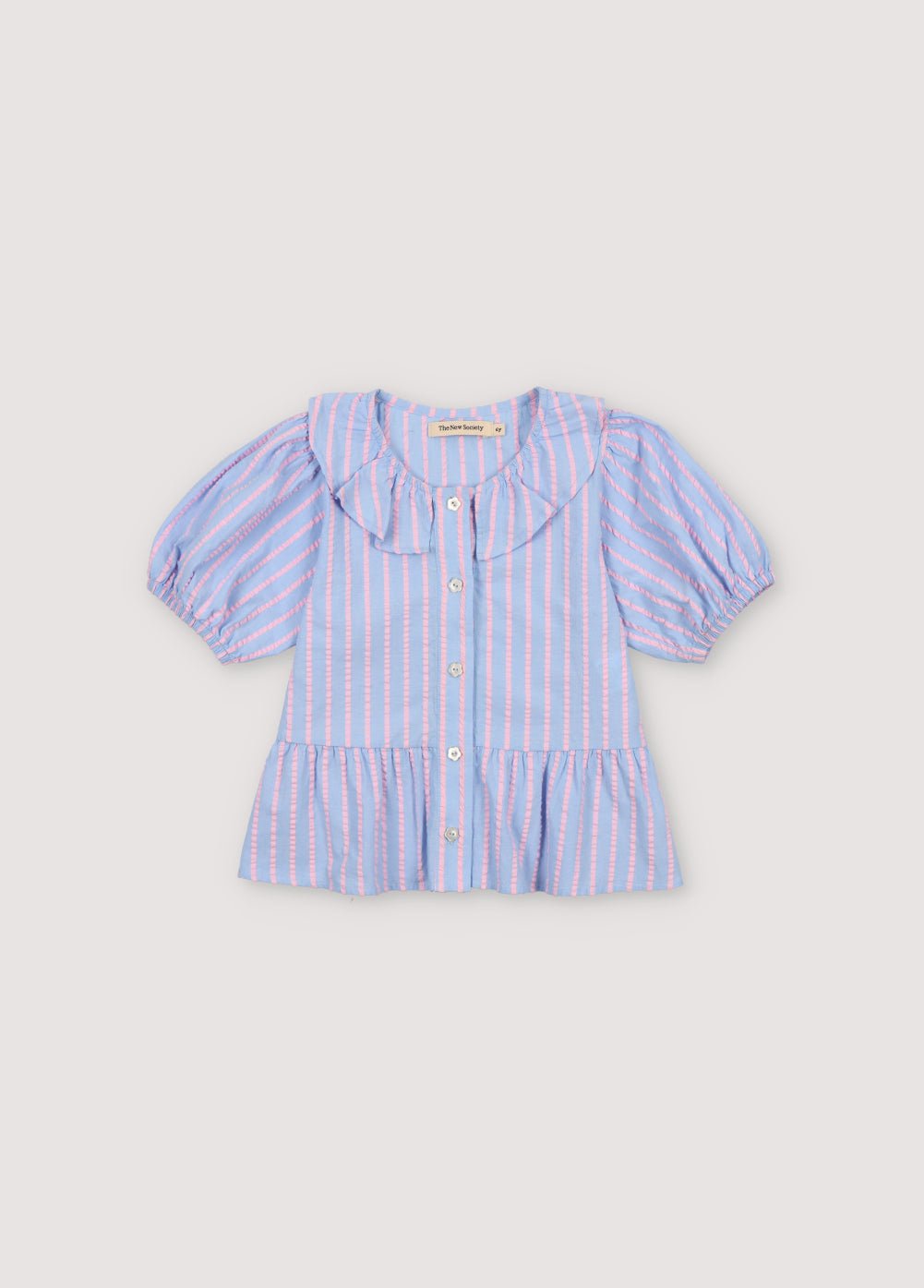 Kythira Blouse in 100% cotton striped fabric with cut details and ruffles at the hem, ruffled neckline, puffed short sleeves, and mother-of-pearl flower-shaped buttons.