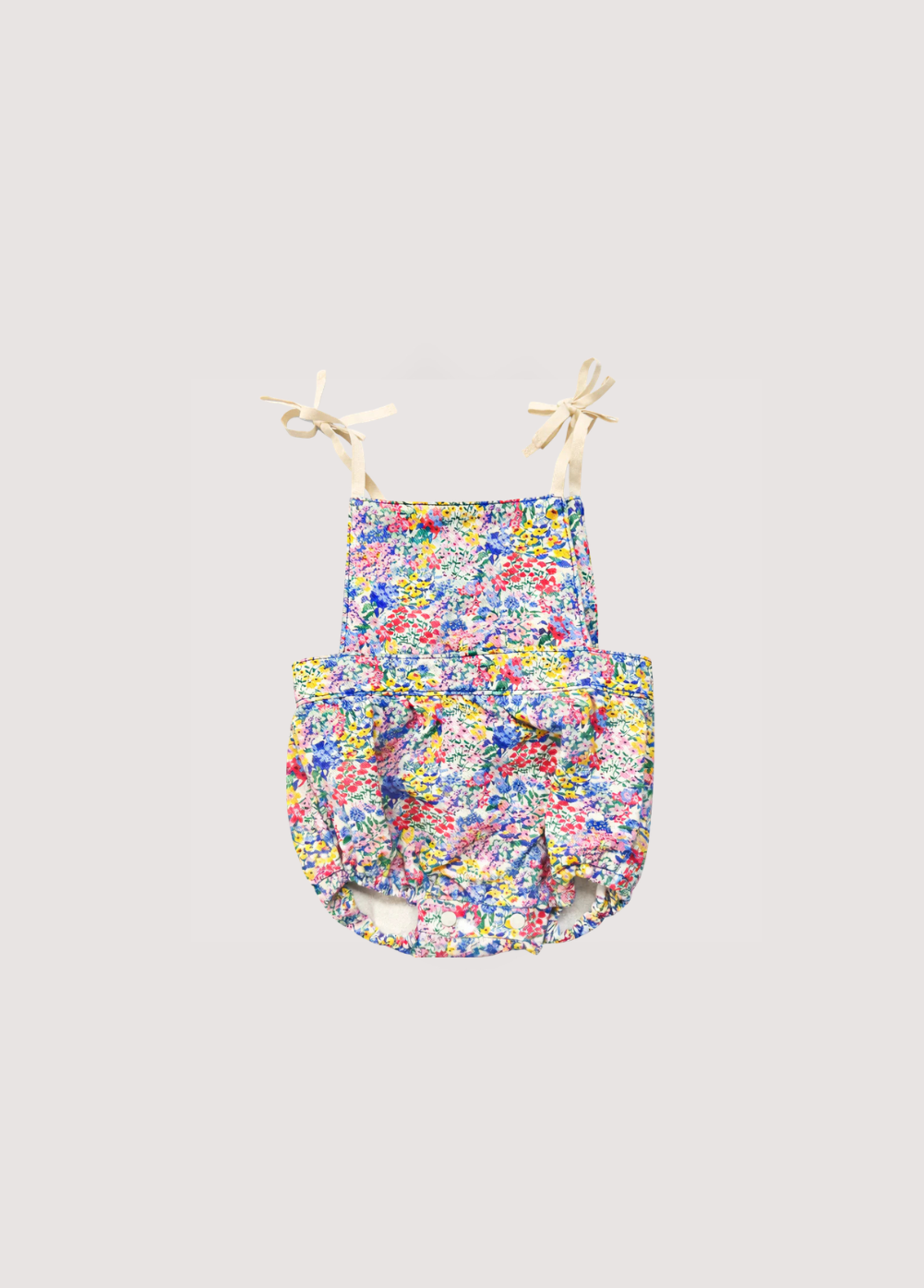 Baby denim romper crafted from 100% BCI cotton with a beautiful floral print. 