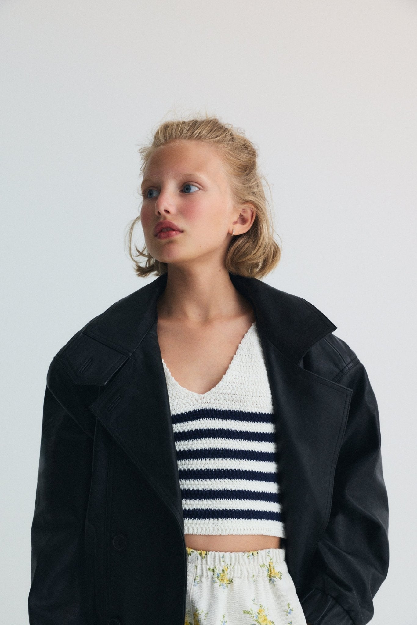 Crop knit top with a V neckline and thin straps, featuring two color nautical style stripes for a fresh, summery feel.