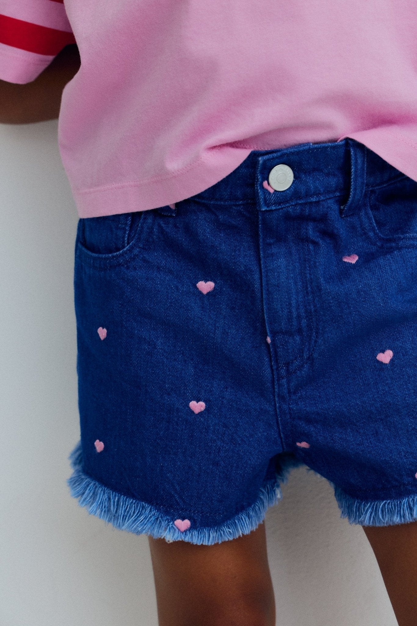 Denim shorts crafted in soft cotton with pretty all over heart embroidery, adding a playful and delicate touch.