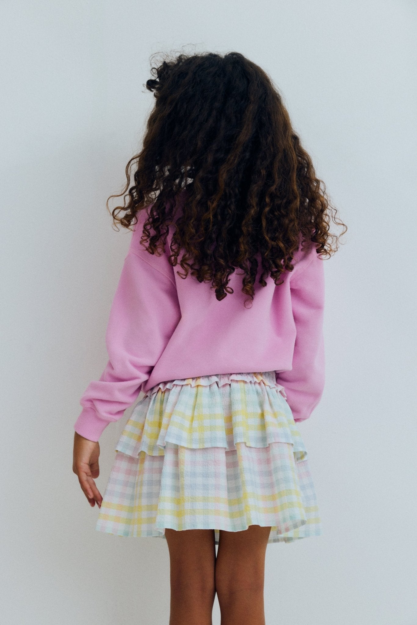 Our classic skirt pattern in cotton seersucker with multicolor checks, featuring smocking at the top for a comfortable fit and a double ruffle that adds movement and charm
