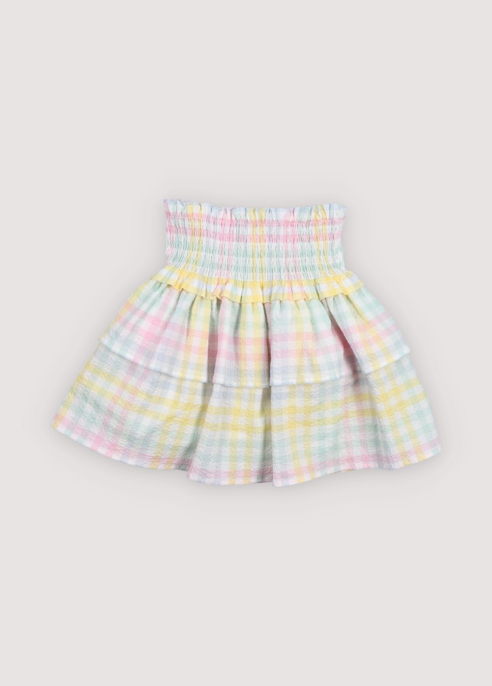 Our classic skirt pattern in cotton seersucker with multicolor checks, featuring smocking at the top for a comfortable fit and a double ruffle that adds movement and charm