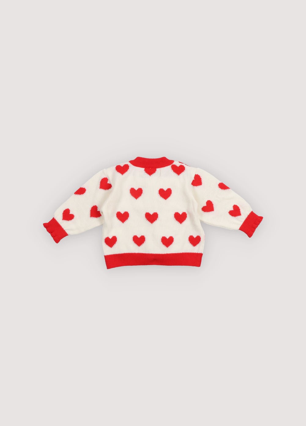 Fine cotton knit cardigan featuring playful contrasting red hearts, contrasting rib trims, and a delicate mother of pearl button closure for a charming, stylish look.