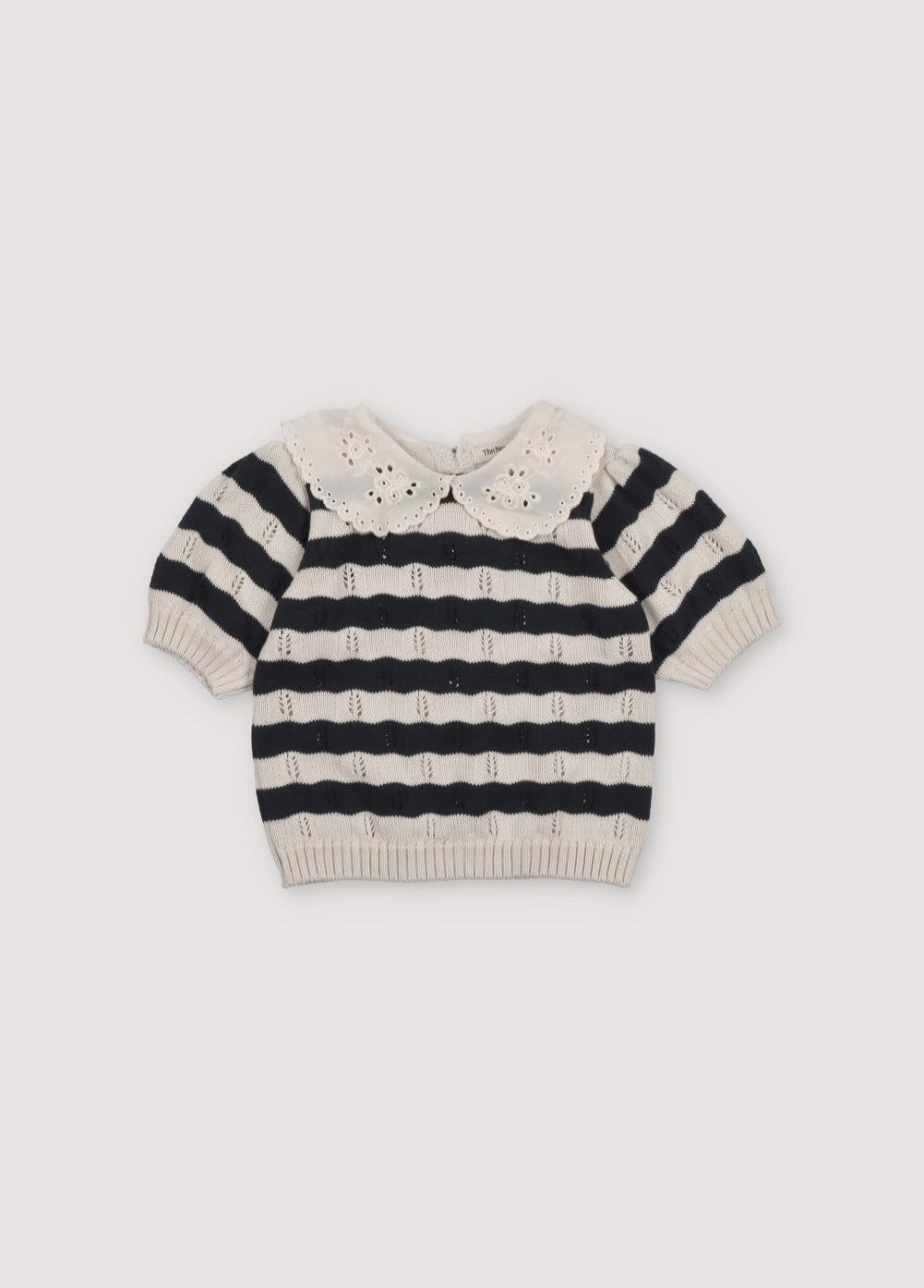 Bicolor striped short-sleeved knit sweater with delicate contrast lace collar detail. It features elastic ribbing at the hem and also elastic cuffs. It's a perfect garment to create a fun total look with the matching pants. The New Society. Spring Summer Collection. 