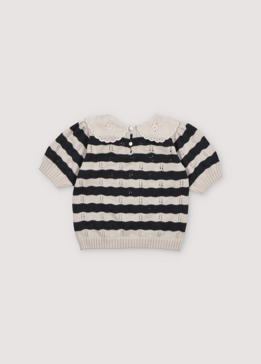 Bicolor striped short-sleeved knit sweater with delicate contrast lace collar detail. It features elastic ribbing at the hem and also elastic cuffs. It's a perfect garment to create a fun total look with the matching pants. The New Society. Spring Summer Collection. 