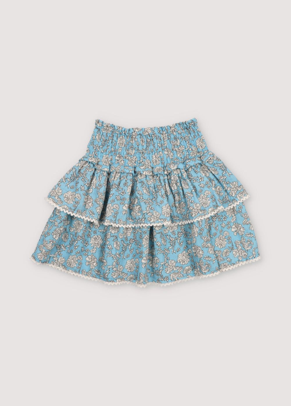 Melina Skirt in 100% cotton muslin with our peony powder blue print. Our iconic skirt with smocking to create volume and two ruffles.
