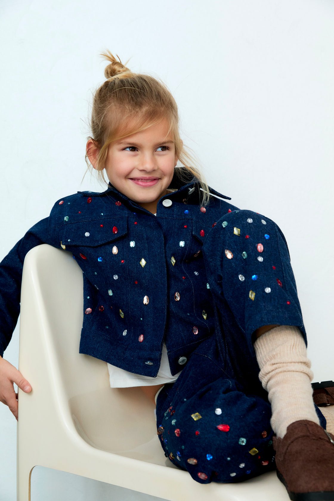 Dark denim jacket with hand-applied multicolored crystal details. TNS embroidery in lurex. Perfect for pairing with the matching pant.