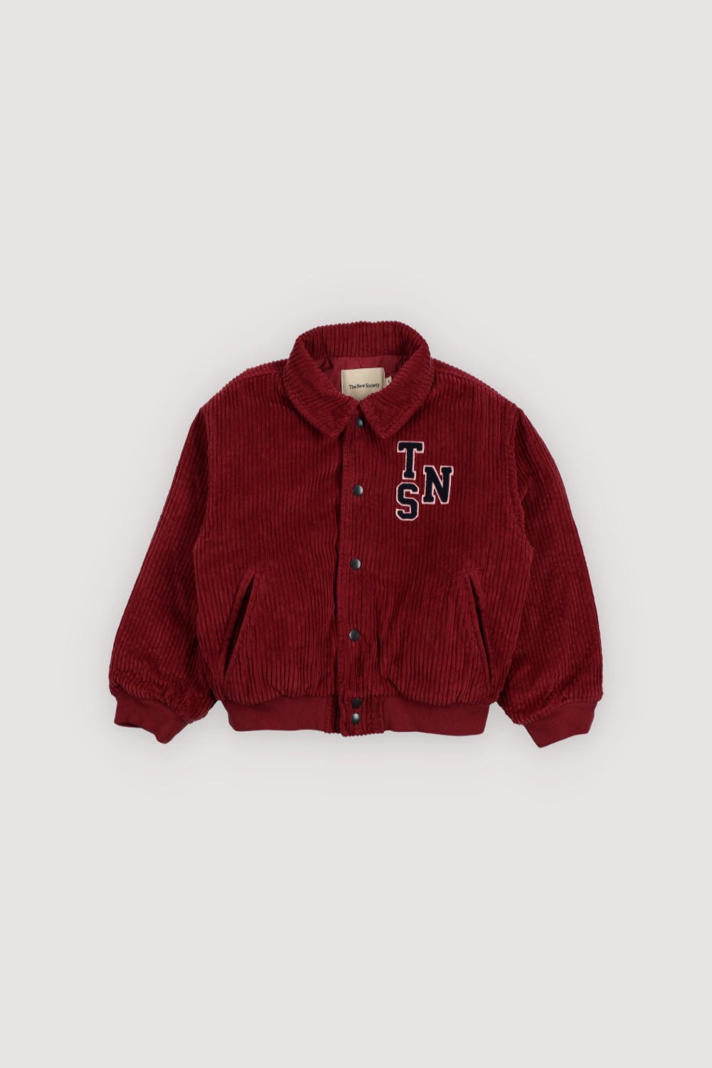 This corduroy bomber jacket in Plum Fantasy features ribbed cuffs and hem in a matching tone for a clean, cohesive look