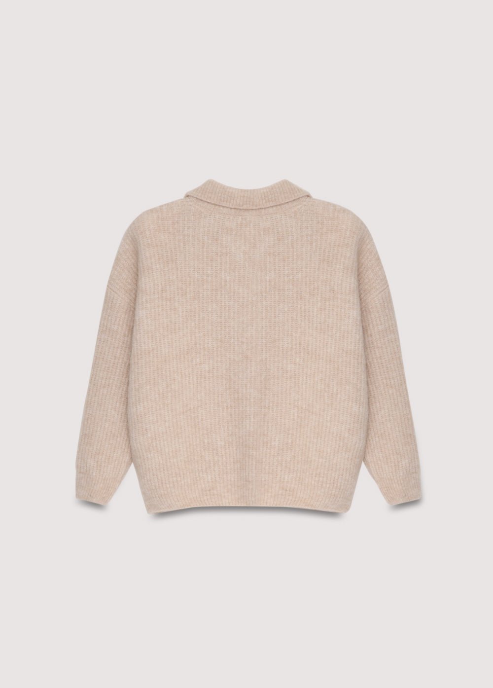 Polo en tricot de laine de qualité exquise, doté d'une ouverture sur le devant avec de beaux boutons ton sur ton.