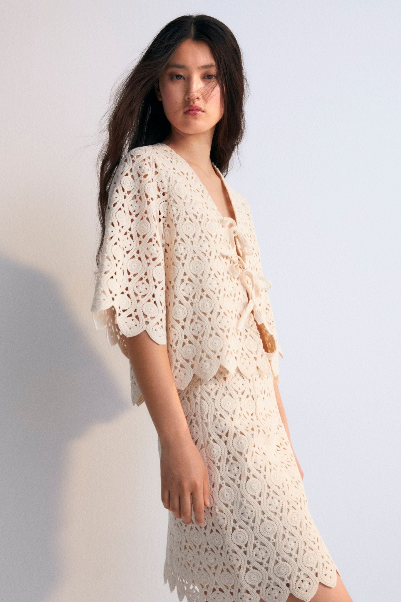 Crochet skirt with inner lining and side slit with invisible zipper. Perfect for creating a coordinated look with the matching top. Spring Summer Collection. The New Society.