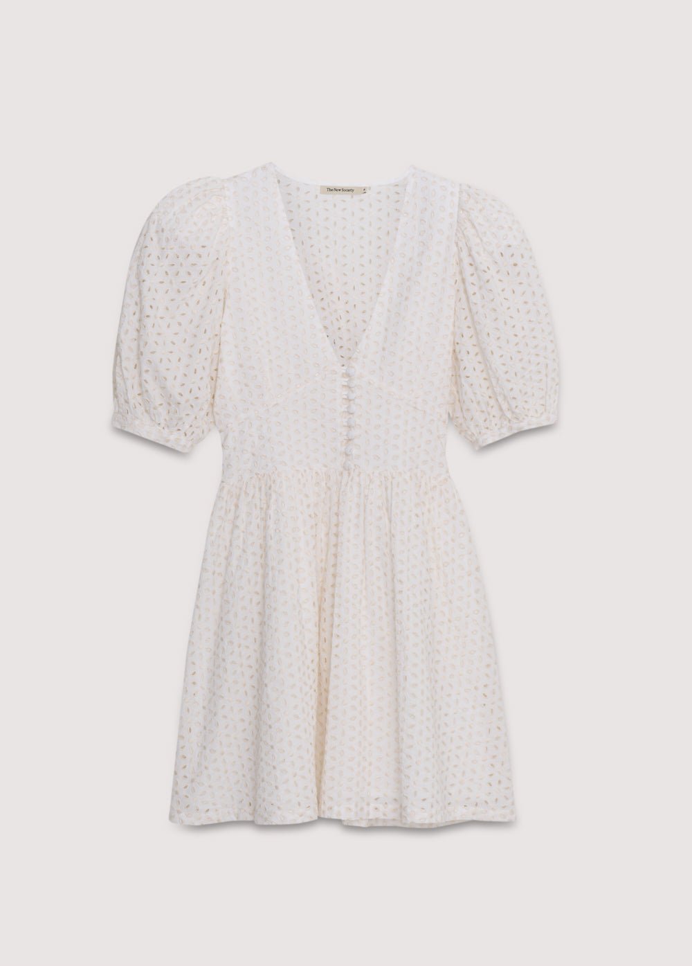 Nemesis Woman Dress in 100% cotton embroidered poplin. It features a V-neck, long billowy sleeves, and a fitted waist. It closes at the front with buttons covered in the same fabric. Spring Summer Collection. The New Society. 
