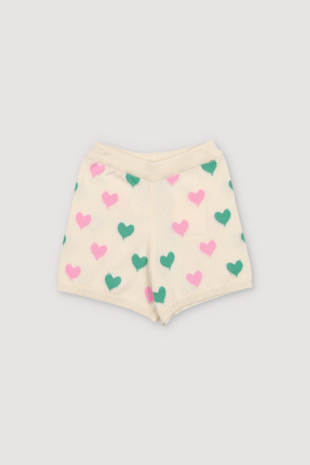 Knit shorts with a playful two-color heart intarsia pattern and ribbed elastic waistband. It has a matching top to create a perfect summer look. Spring Summer Collection. The New Society. 