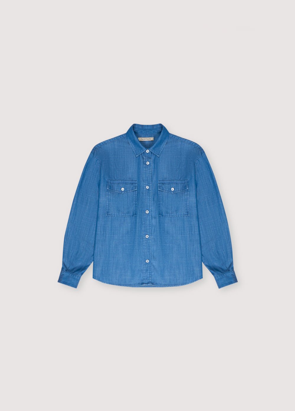 Ophelia Teen Shirt in 100% tencel. Wide long-sleeve shirt with a shirt collar, two front pockets, and a central button closure. Spring Summer Collection. The New Society. 