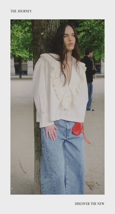 A woman wearing looks from the Campalà Woman AW26 collection in a natural setting. The campaign captures effortless elegance through relaxed poses and authentic moments, highlighting timeless silhouettes, refined details, and comfortable fabrics in seasonal tones.