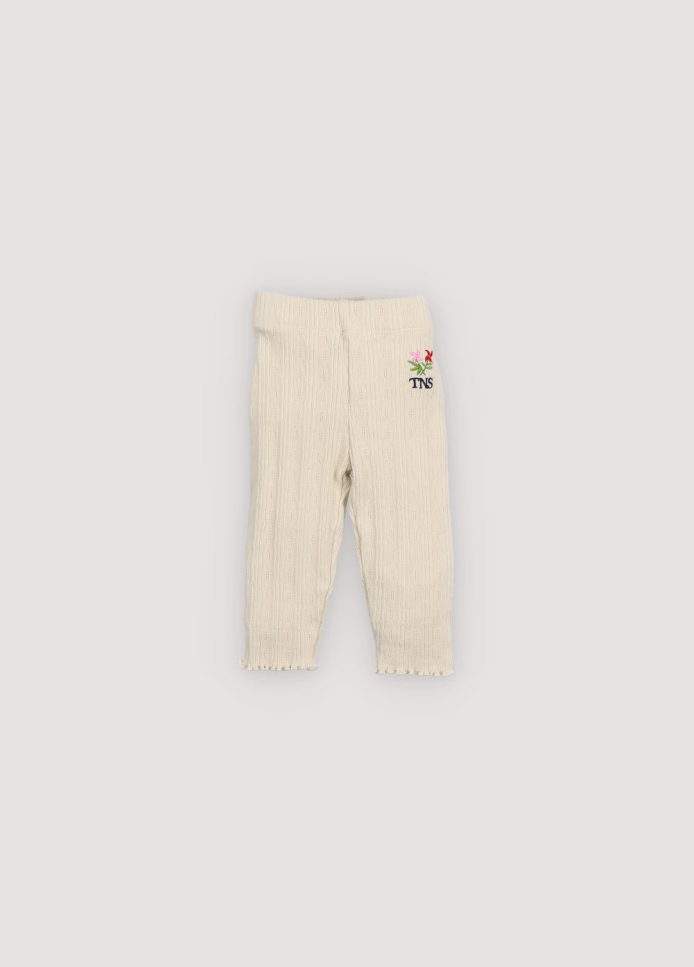 Soft cotton jersey leggings featuring a delicate openwork design, an elastic waistband for everyday comfort, and a small floral brand embroidery on the front for a subtle, special touch.