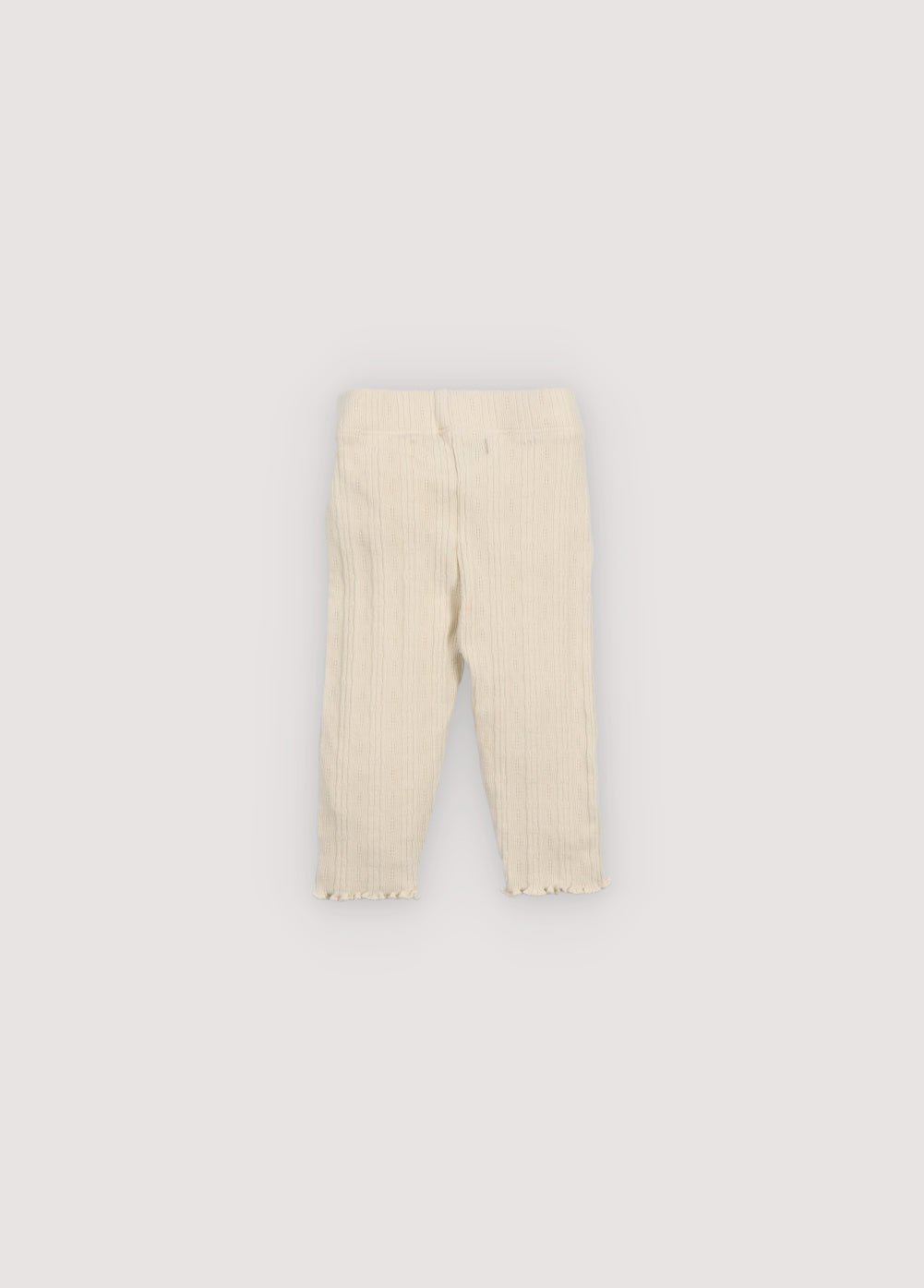 Soft cotton jersey leggings featuring a delicate openwork design, an elastic waistband for everyday comfort, and a small floral brand embroidery on the front for a subtle, special touch.